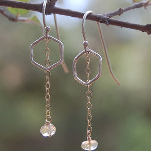 earrings of tiny hexagons with a gold chain hanging down with a bead of citrine at the end like a honey drop