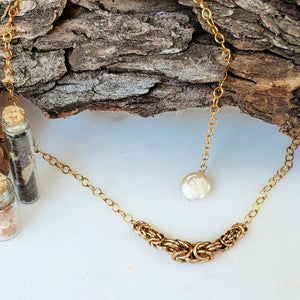 gold necklace with pearl accent