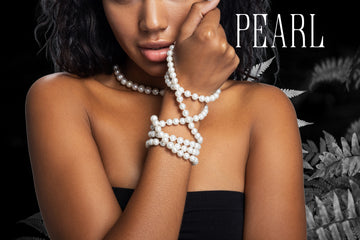 Woman with white pearls wrapped around her wrist. Pearl is the birthstone for June.