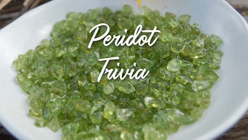 peridot august birthstone kbeau jewelry a small, shallow bowl full of chipped peridot beads