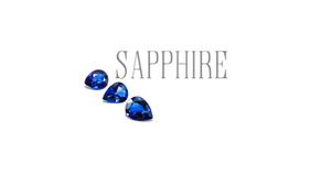 sapphire gems birthstone for September three faceted blue sapphires on white background