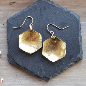 hammered brass hexagonal earrings on slate