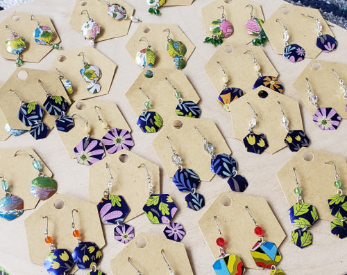 Colorful hexagonal earrings  made from tea tins some with beads or crystals 