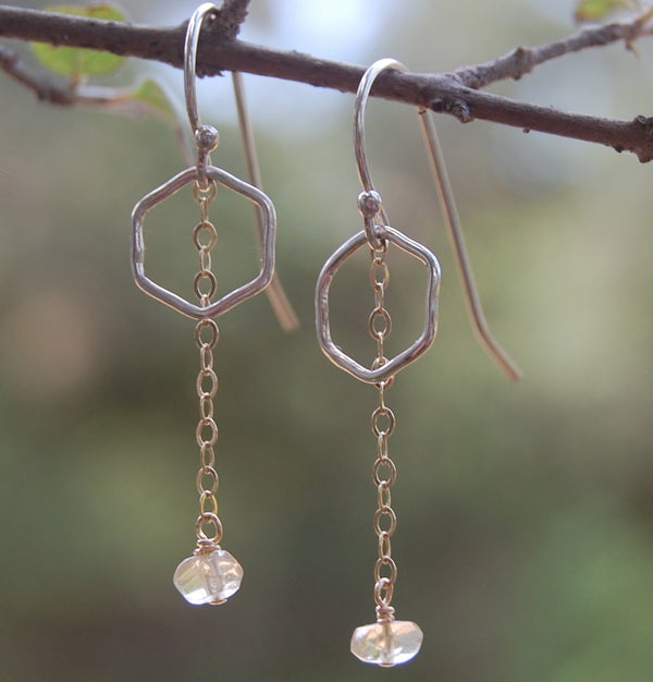 earrings of tiny hexagons with a gold chain hanging down with a bead of citrine at the end like a honey drop